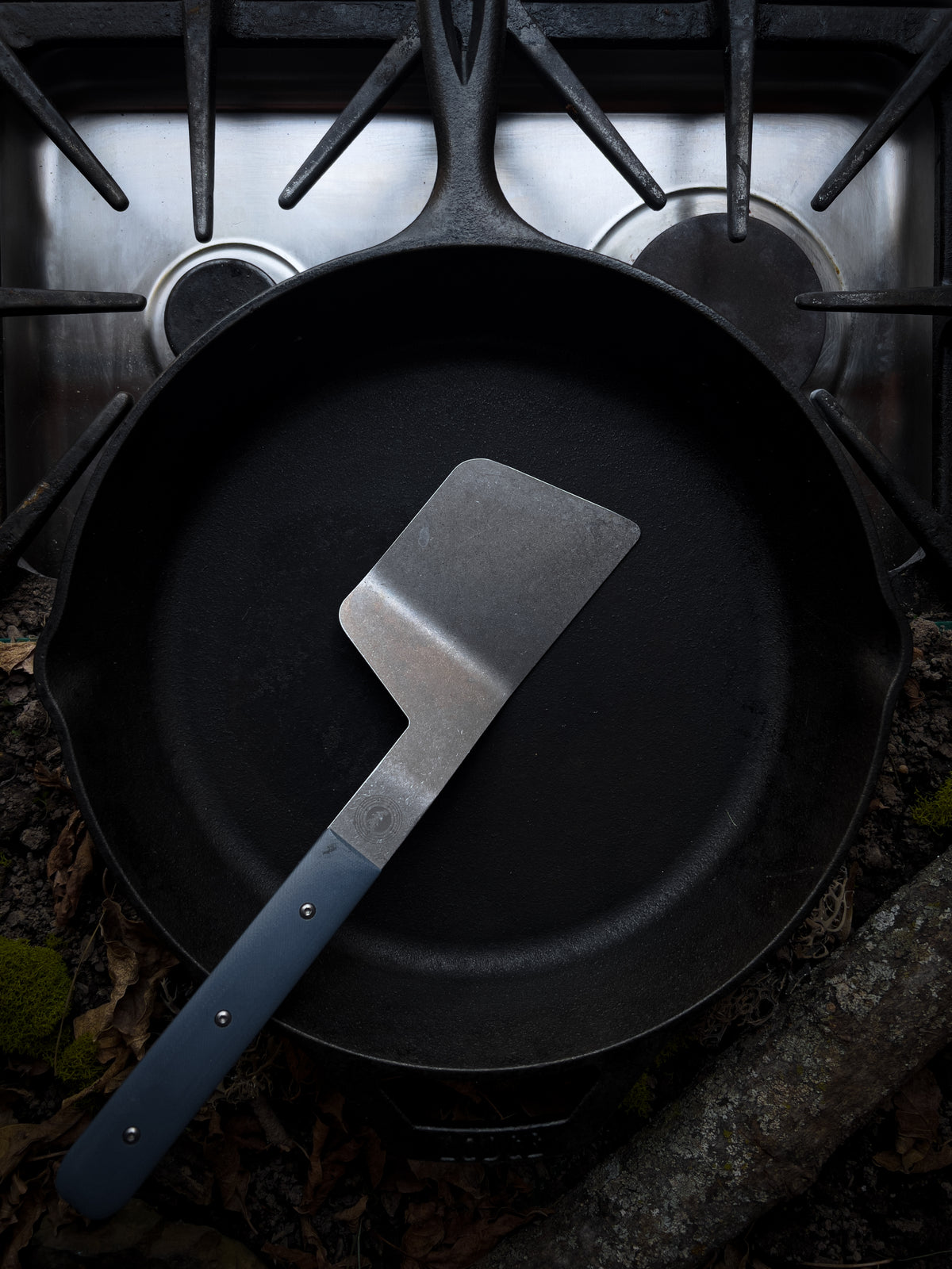 full size cast iron spatula with blue handle