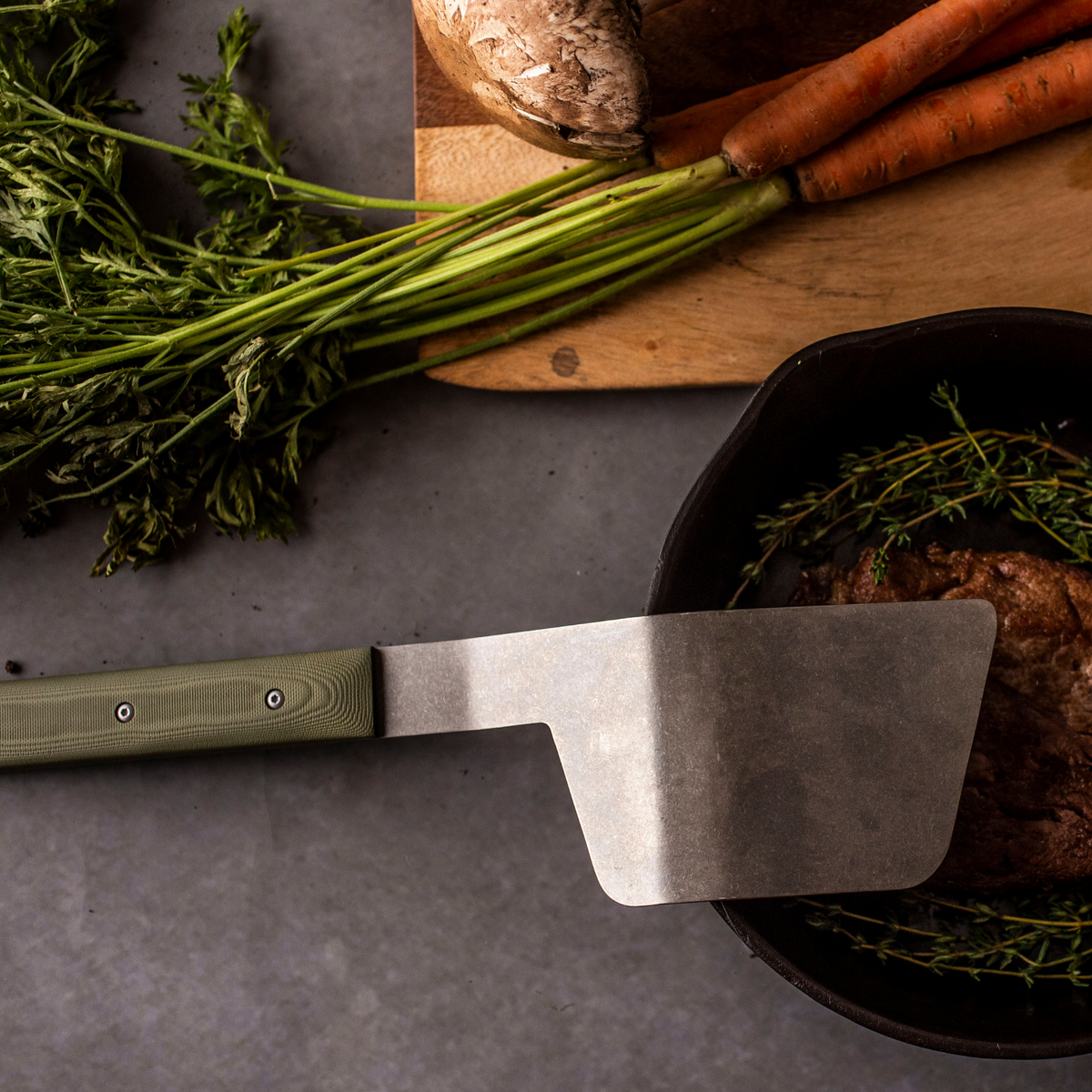 full sized spatula sitting on a countertop with prepared food