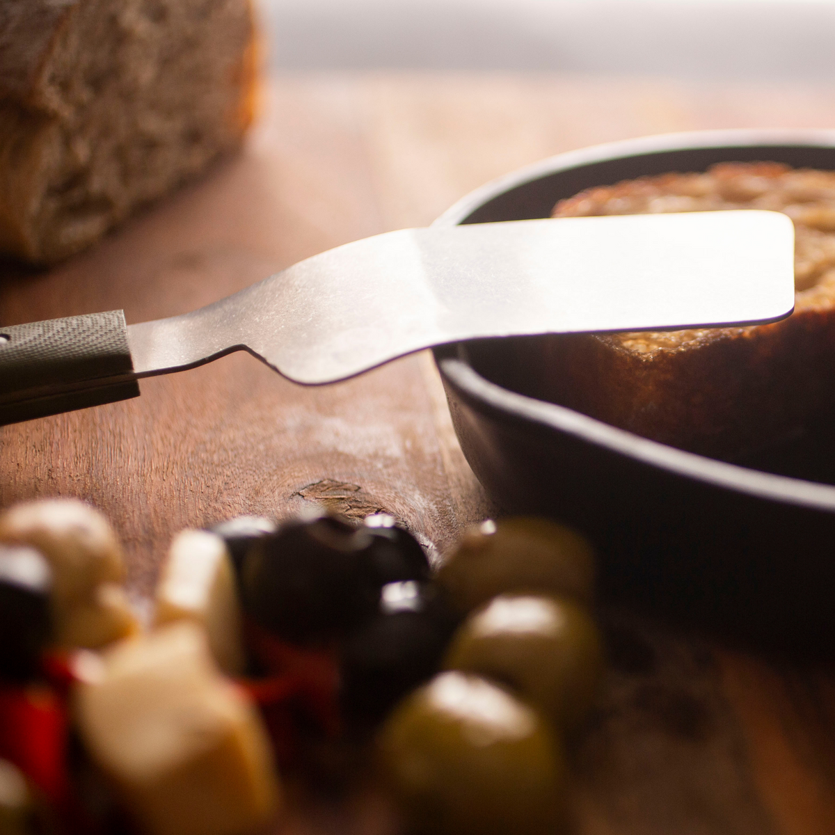 a mini spatula sitting on the edge of a pan